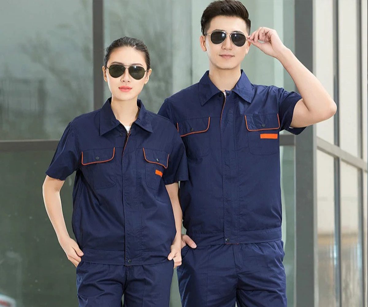 Industrial uniforms in Abu Dhabi — workers in safety coveralls and hi-vis vests